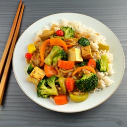 A medley of fresh vegetables and tofu stir-fried in a savory ginger-soy sauce, served over steamed jasmine rice.